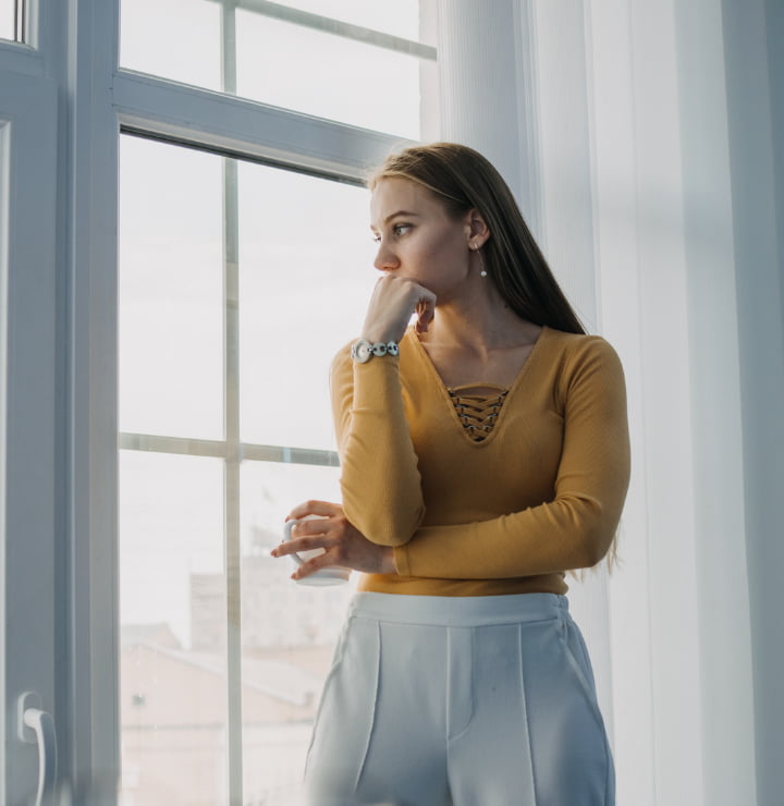 woman looking out her window